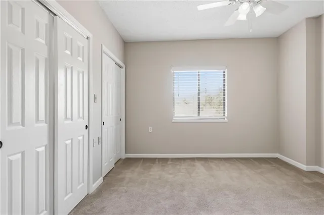 a bathroom with a granite countertop sink a toilet and a bathtub