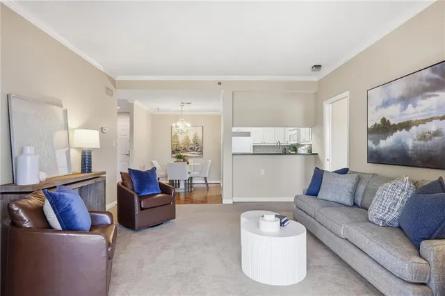 a living room with furniture and kitchen view