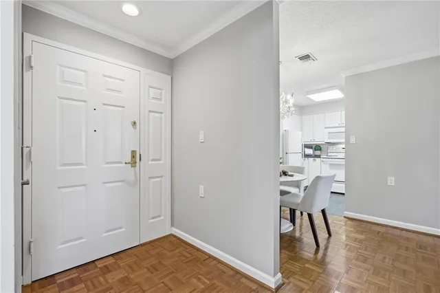 a dining room with furniture a chandelier and wooden floor