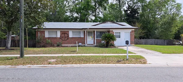 a front view of a house with a yard and porch