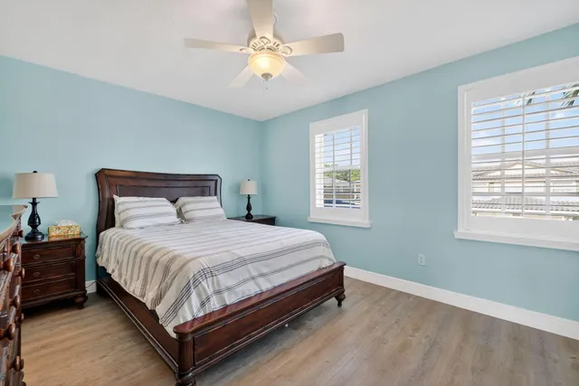 a front view of a house with a garden and plants