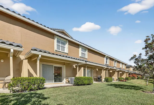 a man walking down a street next to a building