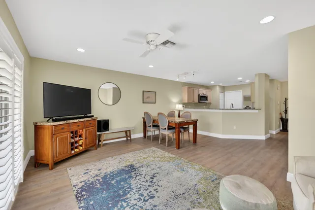 a living room with furniture a flat screen tv and window