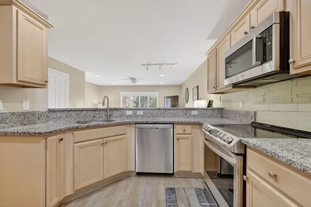 a large bed sitting in a bedroom next to a window