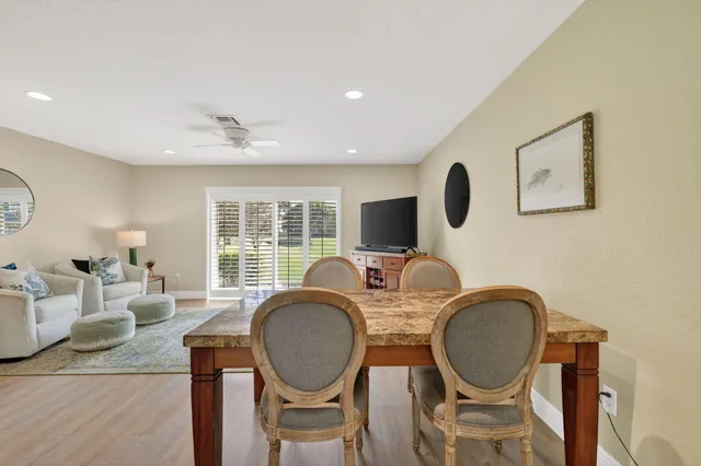a bedroom with a bed a chandelier and a mirror on dresser