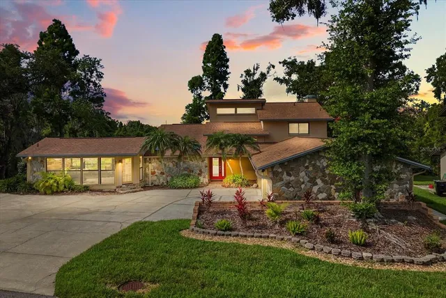 a front view of a house with a yard and outdoor seating