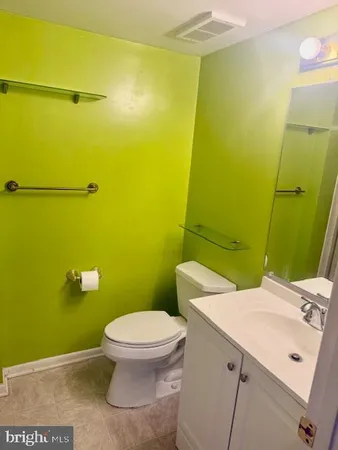 a bathroom with double vanity and a mirror