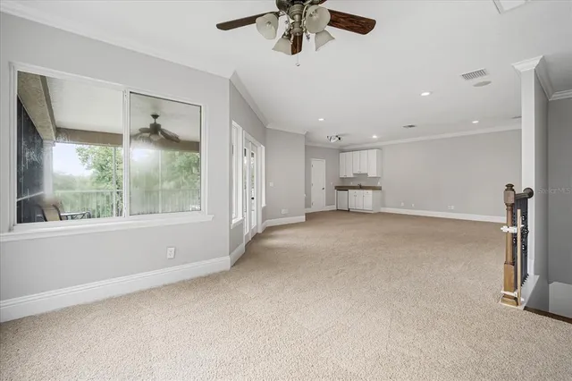 a view of empty room with wooden floor and window