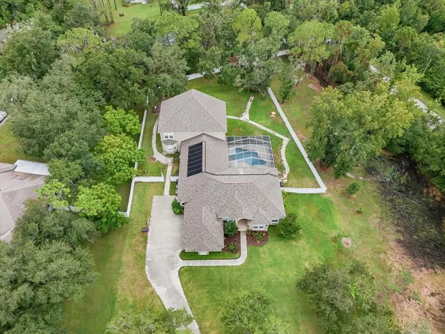 a aerial view of a house with swimming pool and garden
