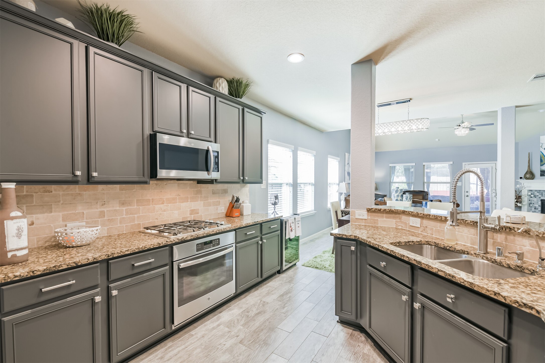 24047 Schults Meadow Lane Spring, TX 77389 - Photo 15 of 47 a kitchen with stainless steel appliances granite countertop a sink stove and cabinets