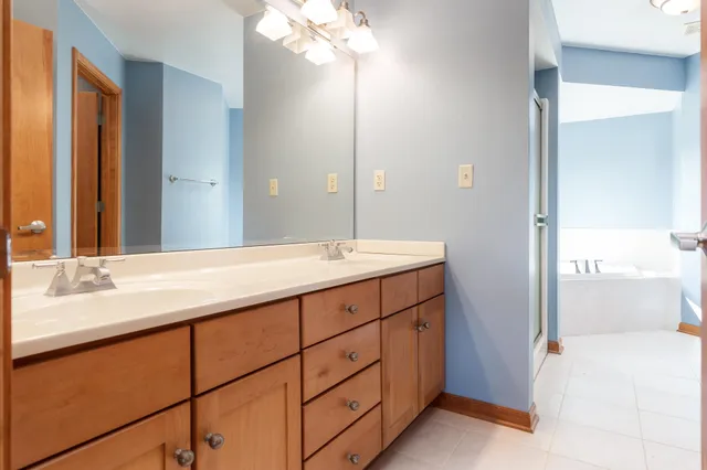 a bathroom with a double vanity sink a toilet and a mirror