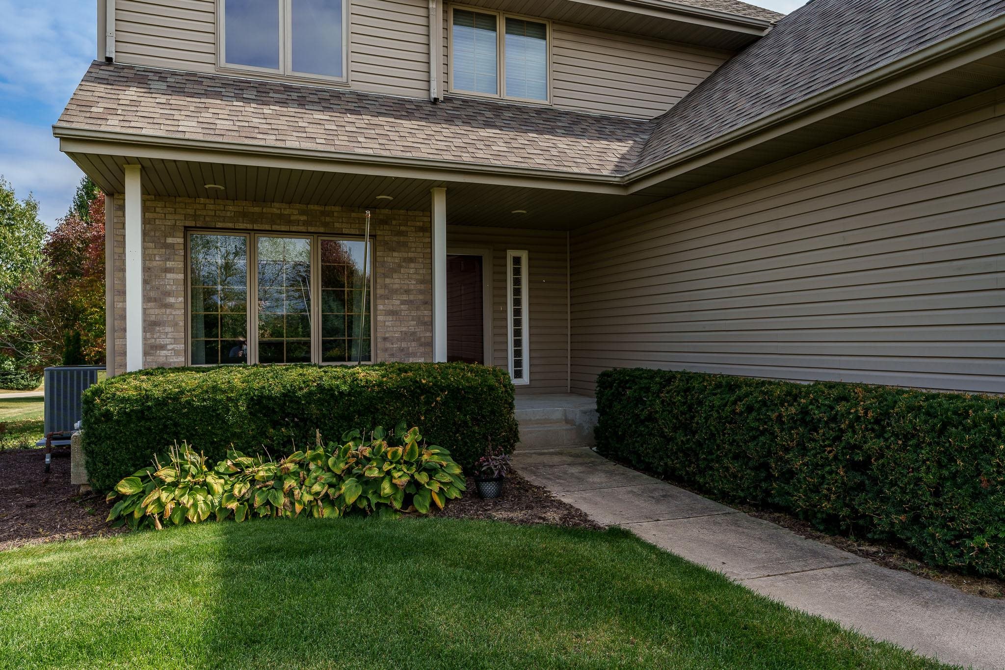 12859 Prairie Meadow Way Belvidere, IL 61008 - Photo 4 of 67 a front view of a house with a garden