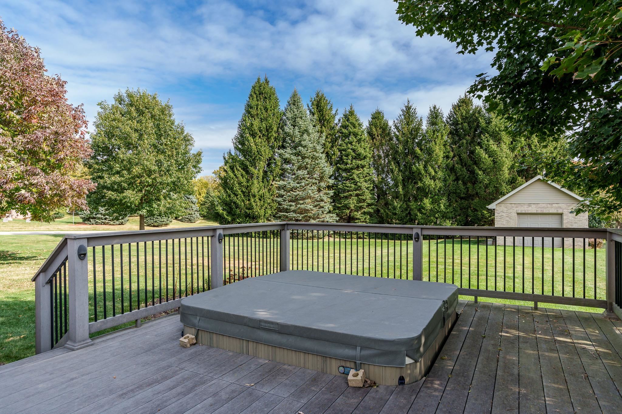 12859 Prairie Meadow Way Belvidere, IL 61008 - Photo 43 of 67 a view of a roof deck with wooden fence and trees