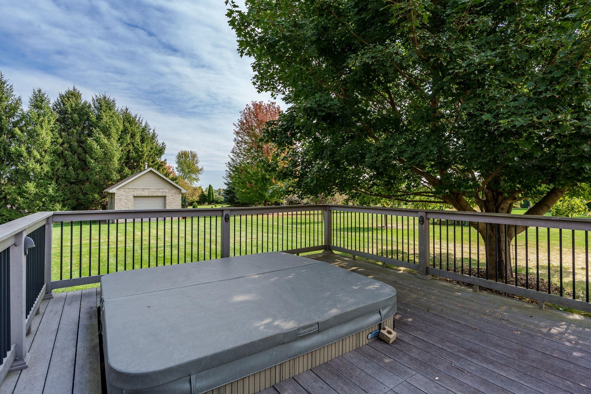 12859 Prairie Meadow Way Belvidere, IL 61008 - Photo 44 of 67 a view of a roof deck with wooden fence and trees