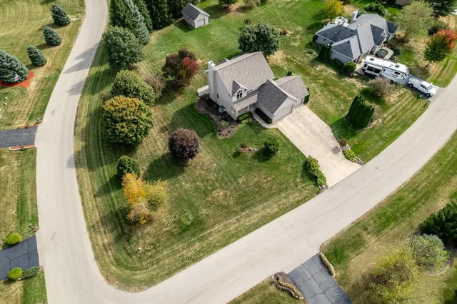 a view of a roof deck with wooden fence and trees