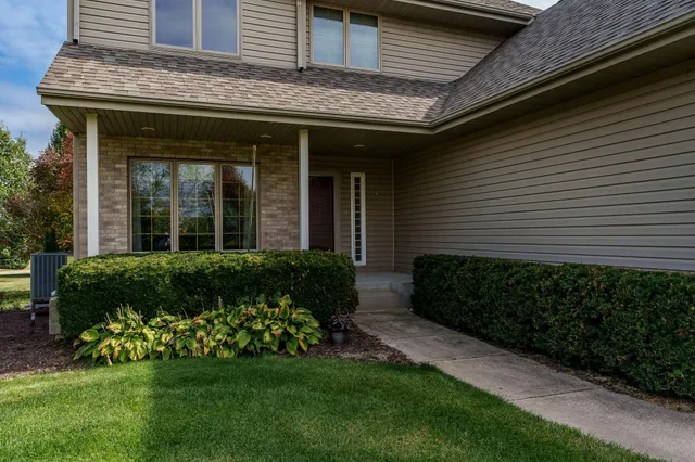 a view of a room with wooden floor and a bathroom