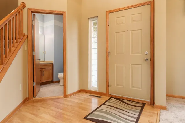 a view of staircase with lots of frames and a rug