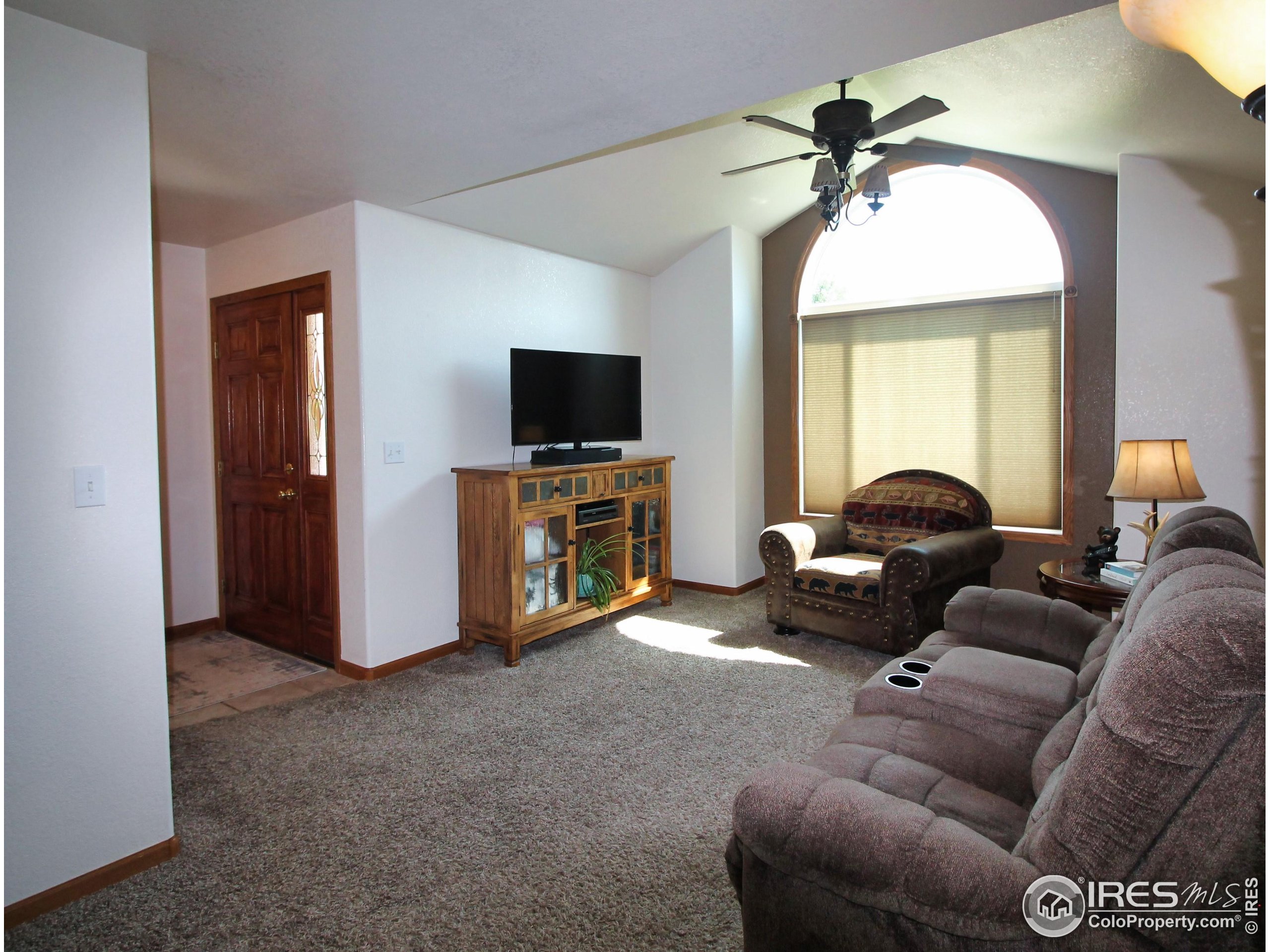 14363 Dakota Road Sterling, CO 80751 - Photo 11 of 40 a living room with furniture and a flat screen tv