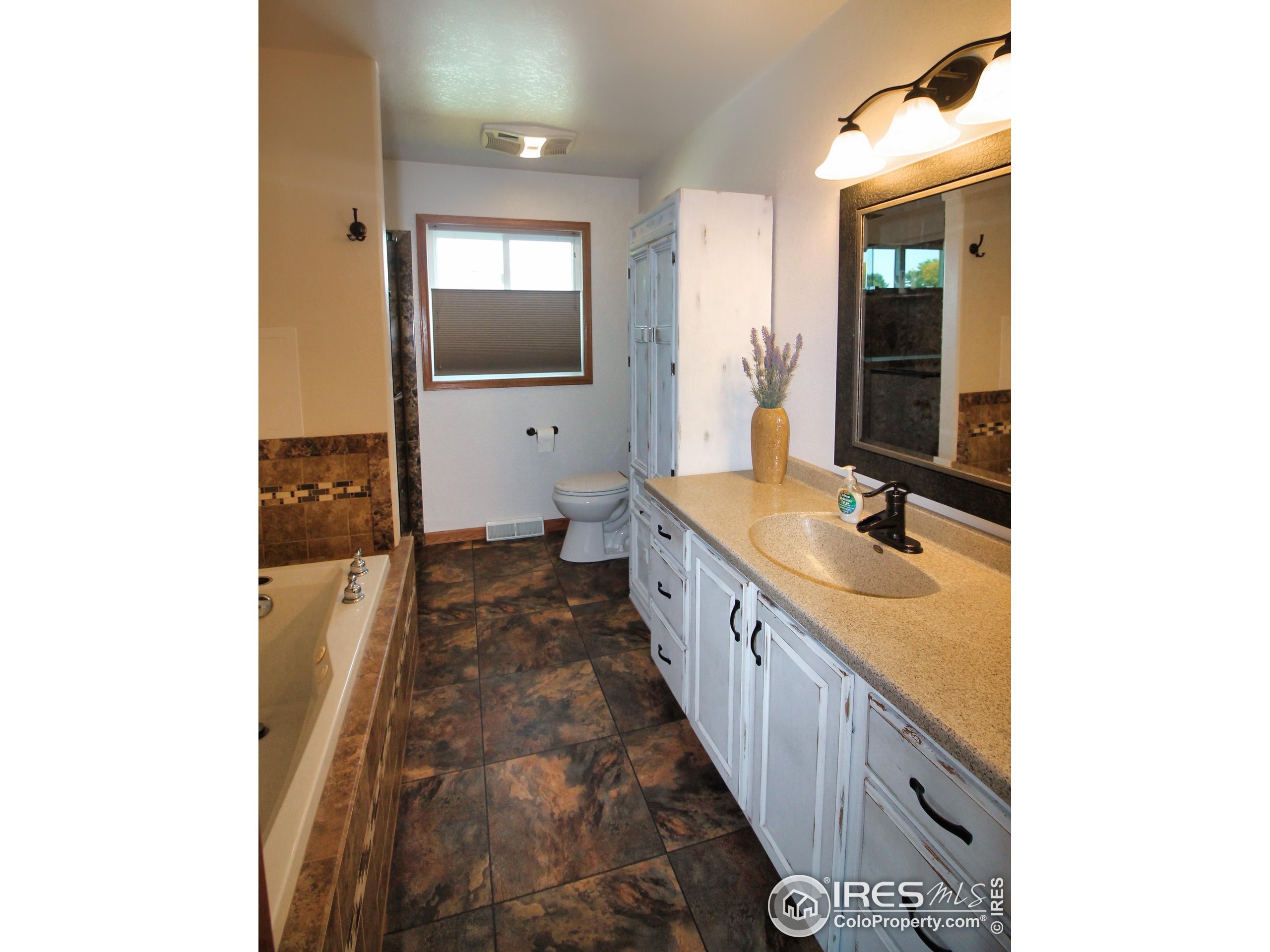 14363 Dakota Road Sterling, CO 80751 - Photo 14 of 40 a bathroom with sink and mirror
