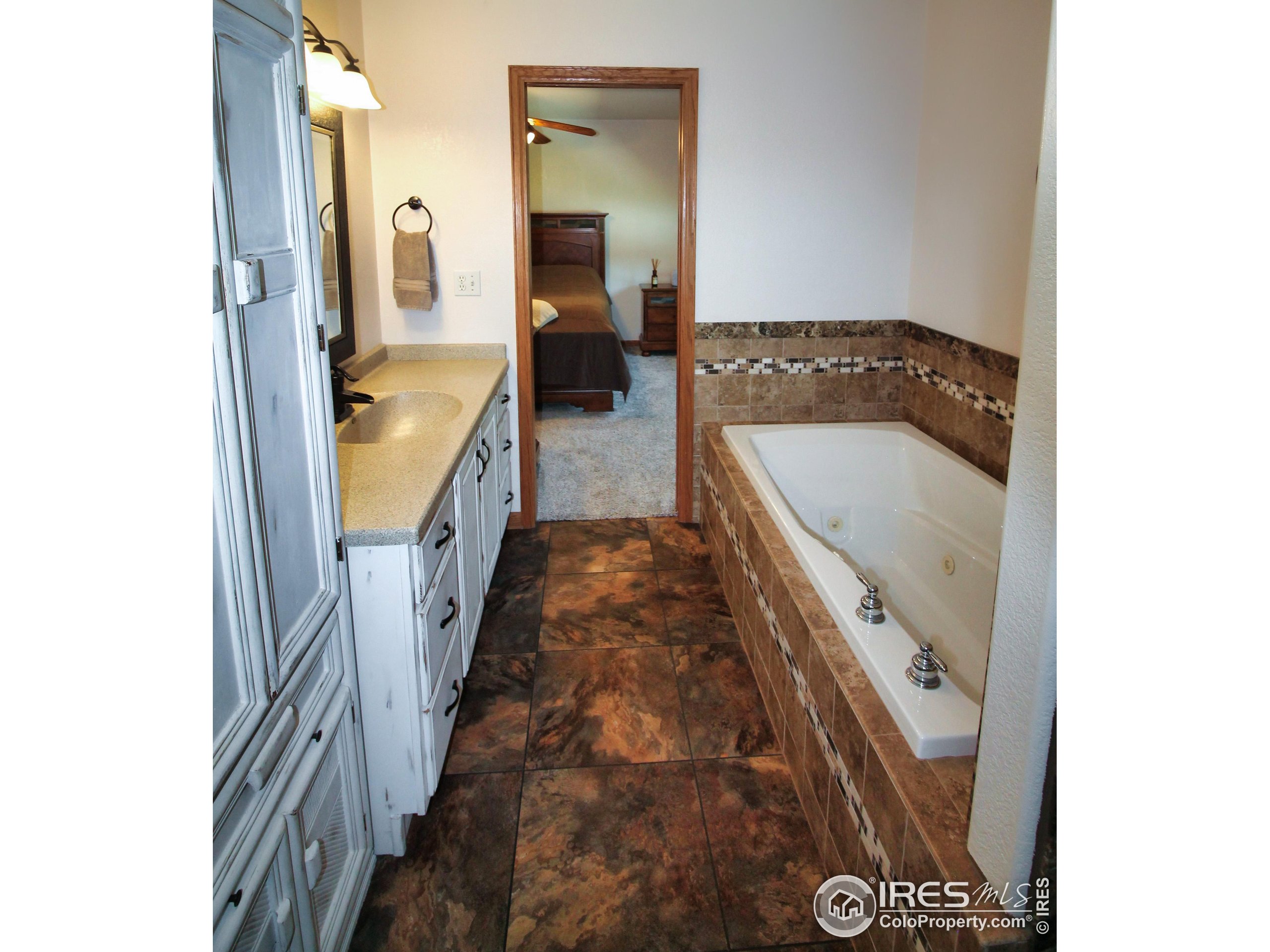 14363 Dakota Road Sterling, CO 80751 - Photo 15 of 40 a en suite bathroom with a sink and a mirror