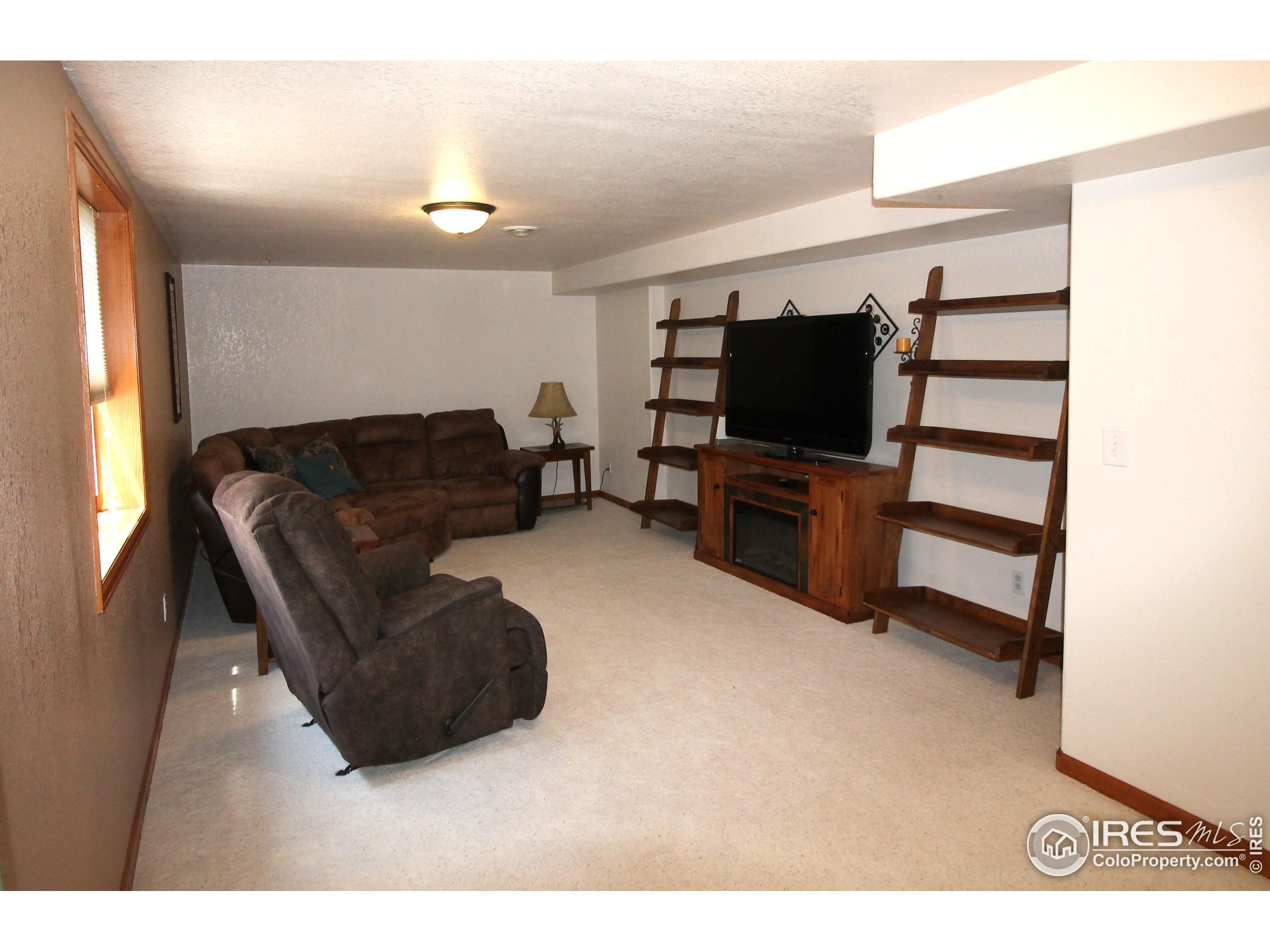 14363 Dakota Road Sterling, CO 80751 - Photo 23 of 40 a living room with furniture and a flat screen tv