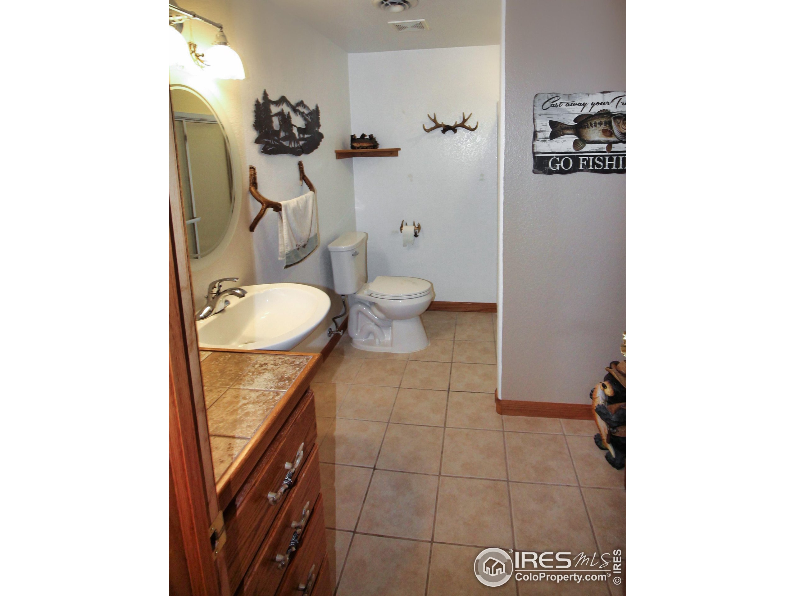 14363 Dakota Road Sterling, CO 80751 - Photo 24 of 40 a bathroom with a toilet and a mirror