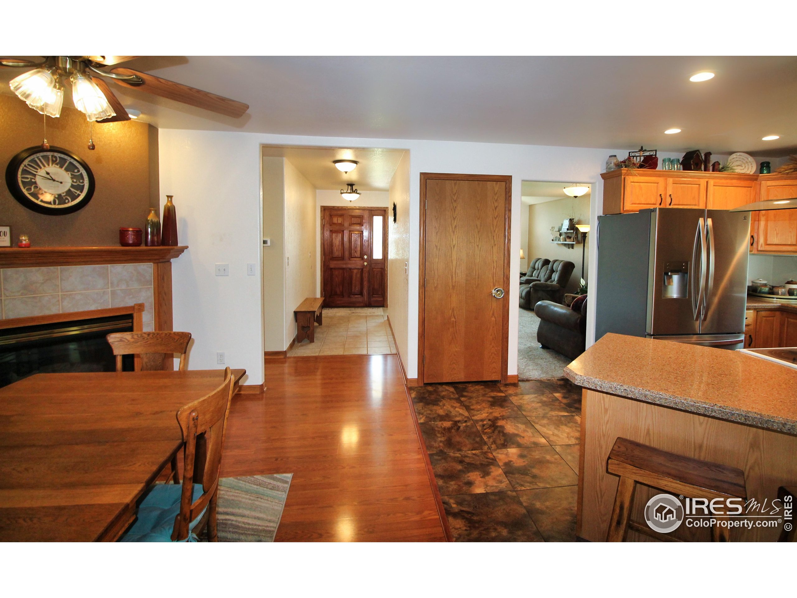 14363 Dakota Road Sterling, CO 80751 - Photo 5 of 40 a open kitchen with stainless steel appliances kitchen island granite countertop a refrigerator and a stove top oven with wooden floor