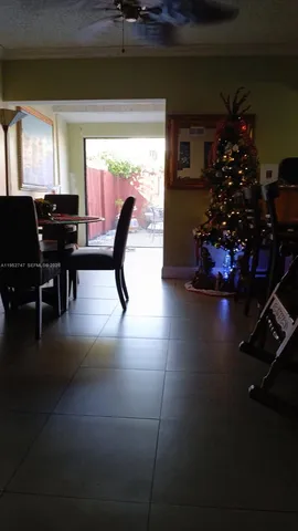 a dining room with furniture and a potted plant