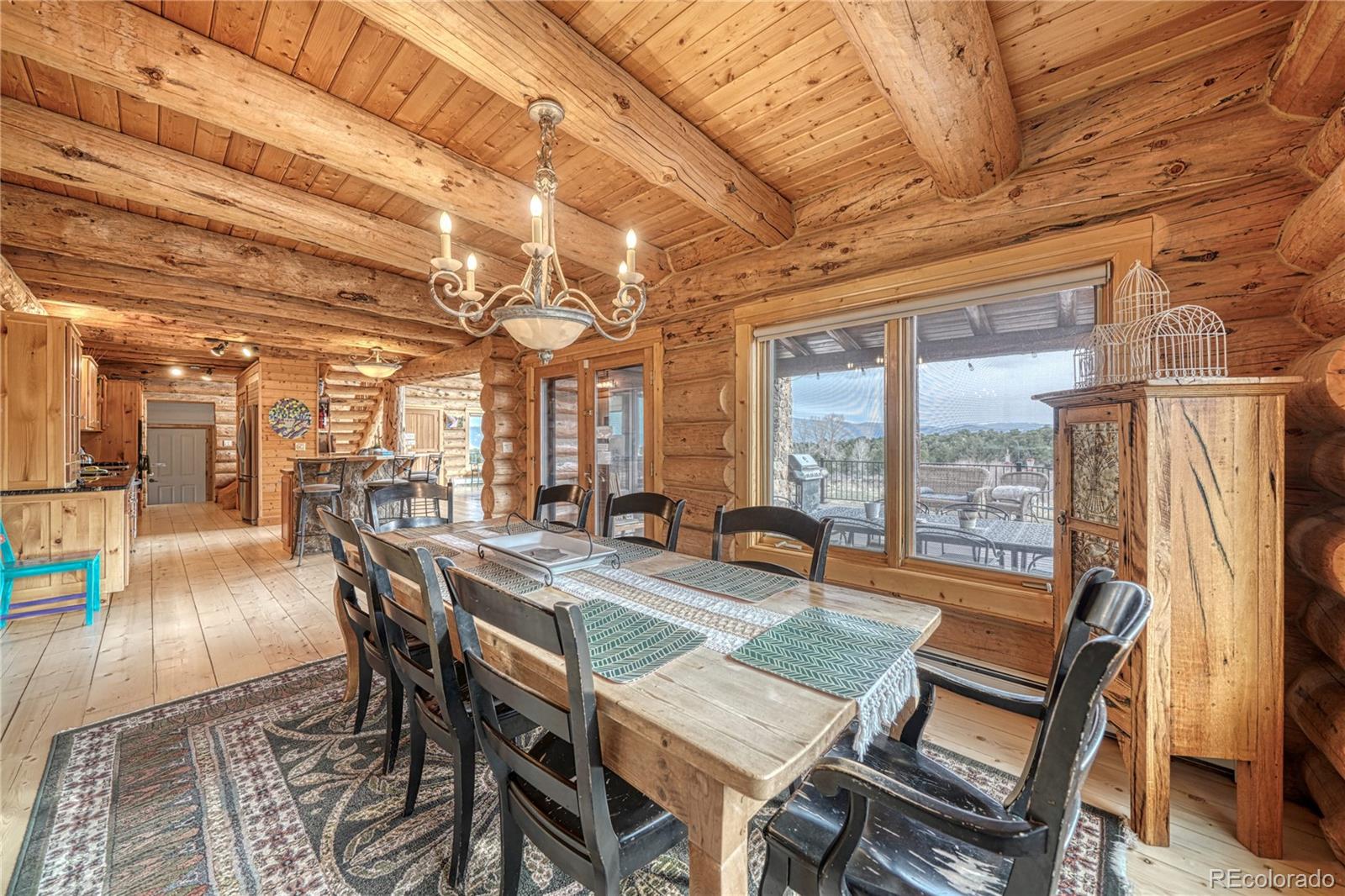 12098 County Road Salida, CO 81201 - Photo 23 of 49 a dining room with furniture a chandelier and wooden floor