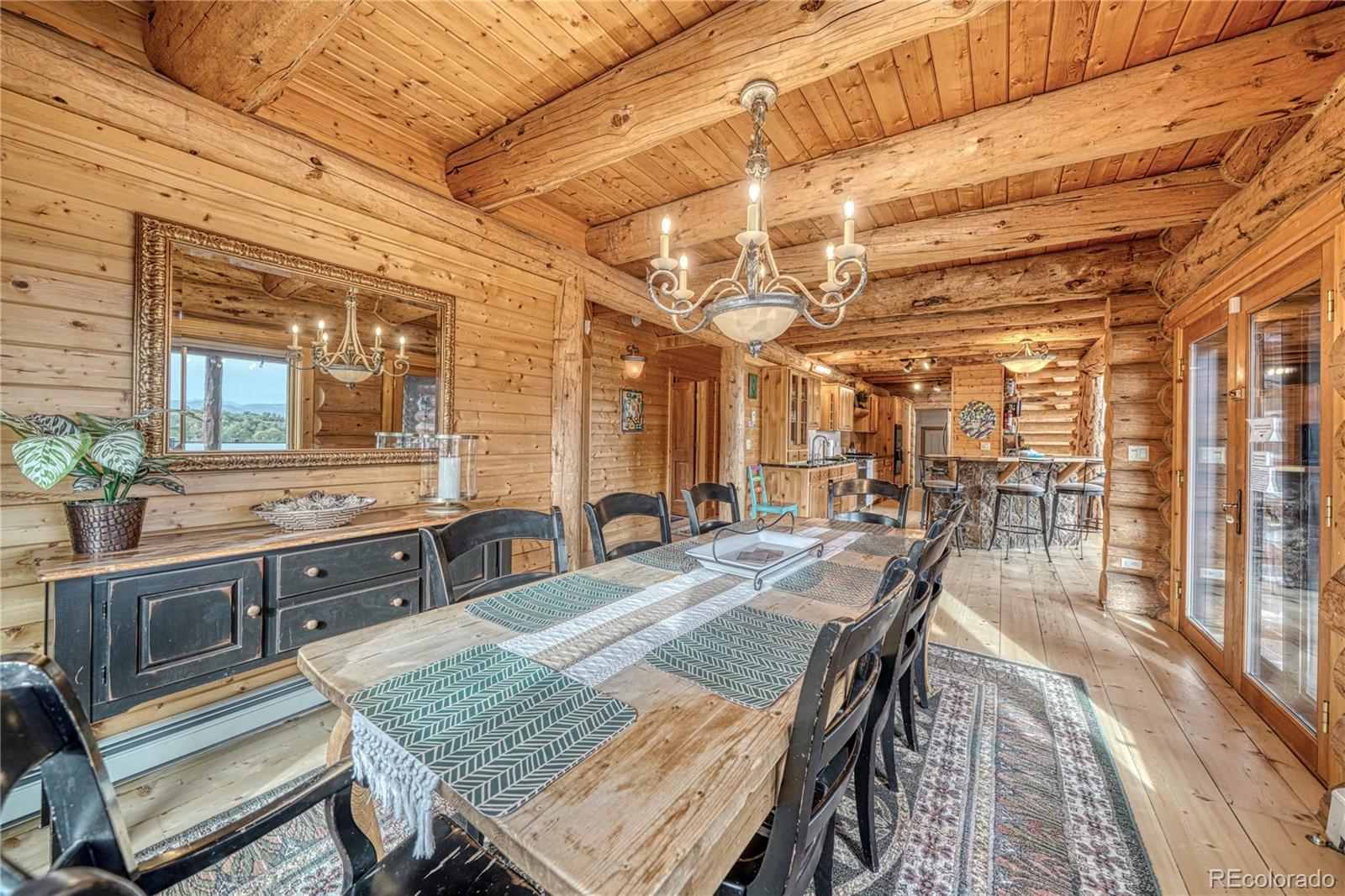 12098 County Road Salida, CO 81201 - Photo 24 of 49 a view of a dining room with furniture a chandelier and wooden floor