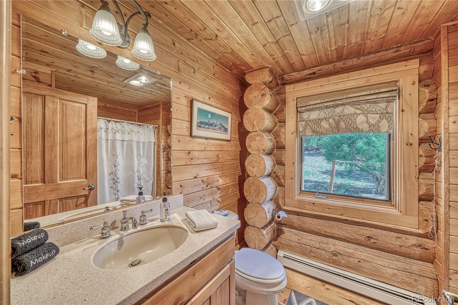 12098 County Road Salida, CO 81201 - Photo 27 of 49 a bathroom with a granite countertop sink toilet and shower