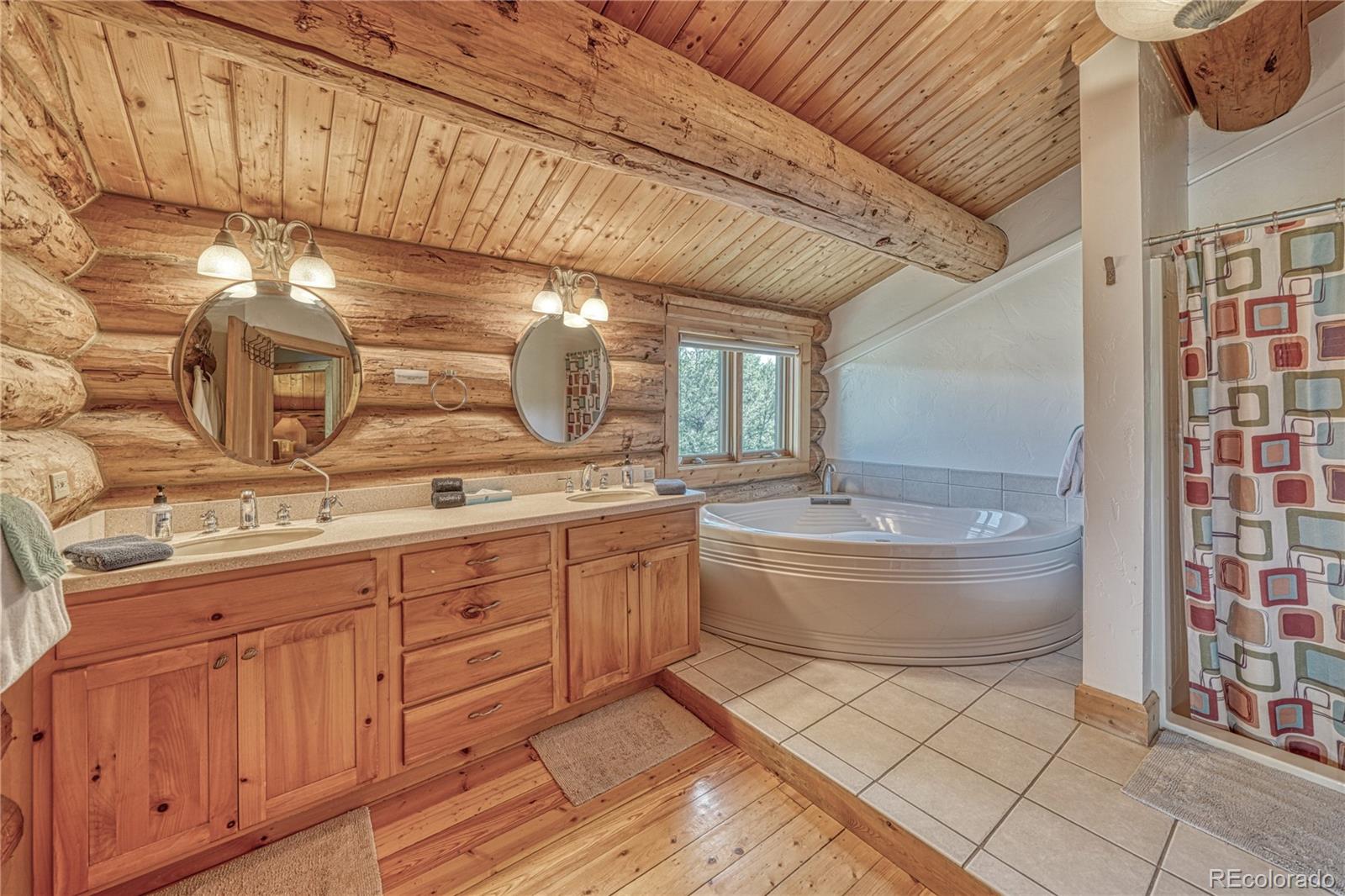 12098 County Road Salida, CO 81201 - Photo 30 of 49 a bathroom with a granite countertop sink a toilet and bathtub