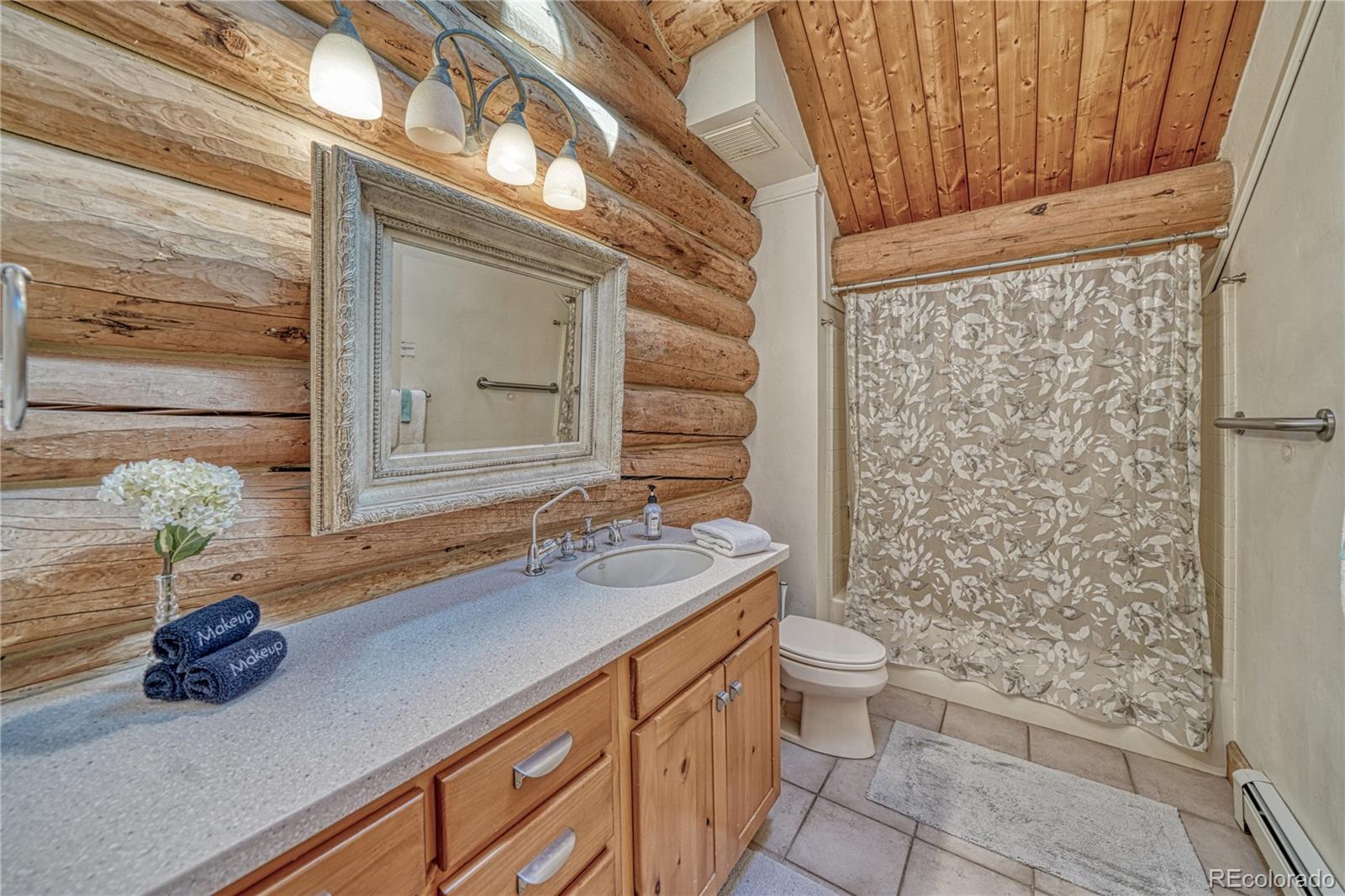 12098 County Road Salida, CO 81201 - Photo 39 of 49 a bathroom with a granite countertop sink a toilet and shower