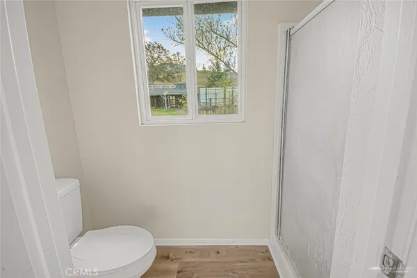 a white toilet sitting next to a window