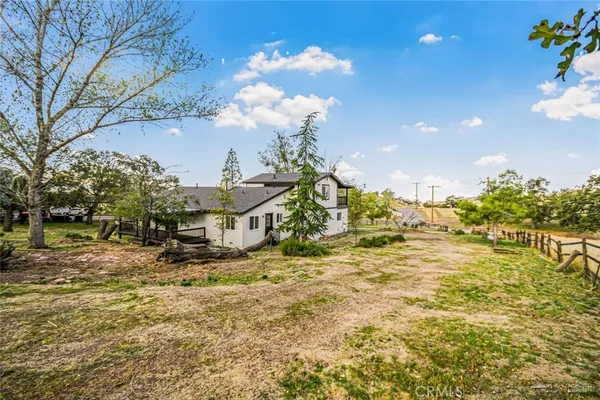 a view of a house with a yard and sitting area