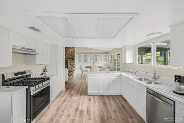 a kitchen with a sink stove and cabinets