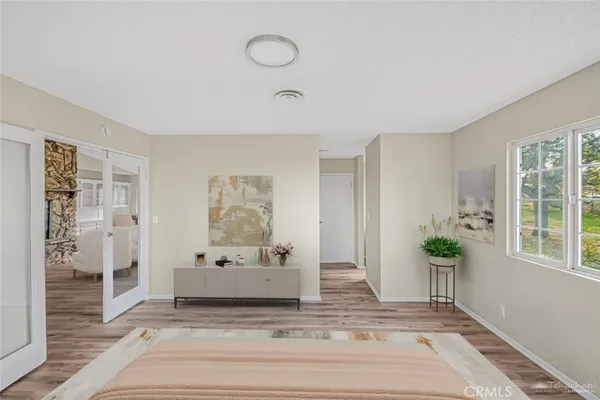 a view of a livingroom with wooden floor and a potted plant