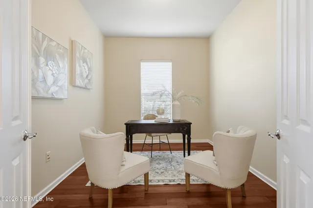 a view of a dining room with furniture window and wooden floor