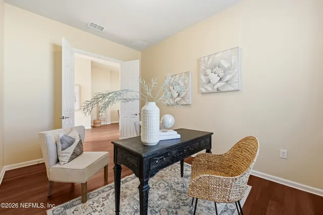 a view of a dining room with furniture and wooden floor