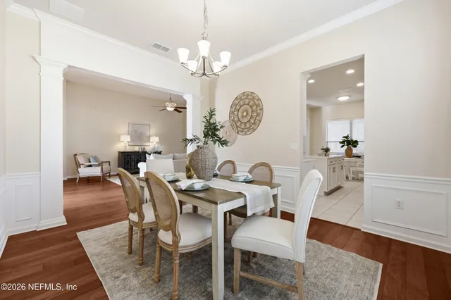 a kitchen with stainless steel appliances a sink a stove a microwave a refrigerator and cabinets