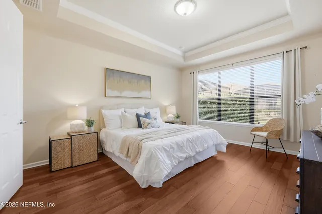 a bedroom with a bed and painting on the wall