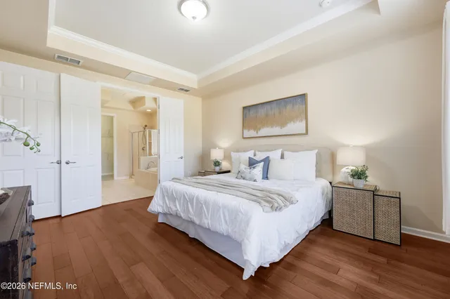 a bedroom with a bed and a chandelier