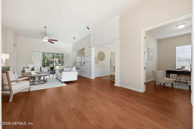 a living room with furniture a rug and a chandelier