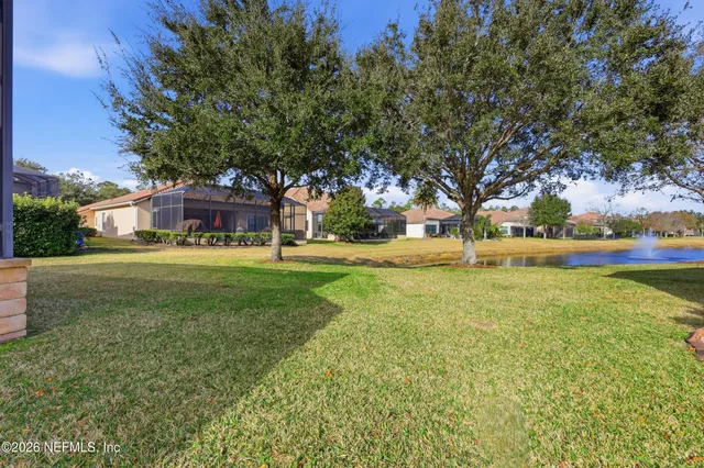 a view of swimming pool with outdoor seating and lake view