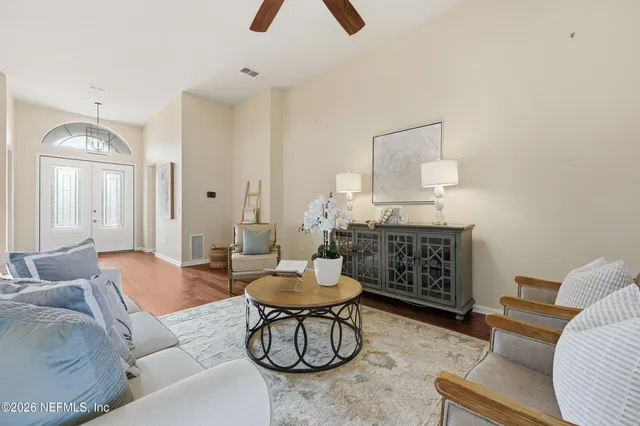a living room with furniture and a wooden floor