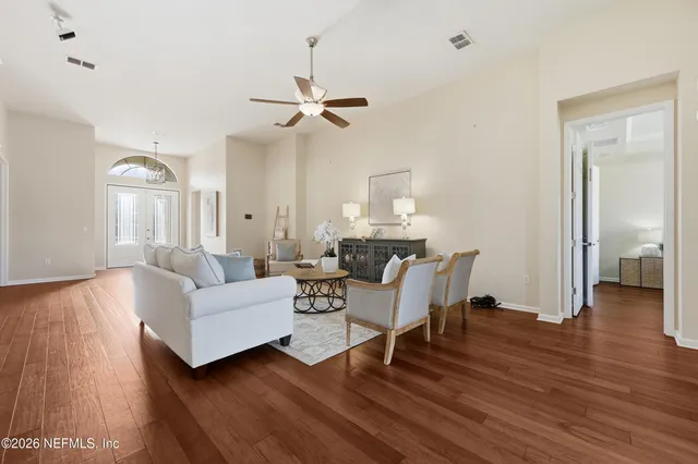 a view of a room with furniture and wooden floor