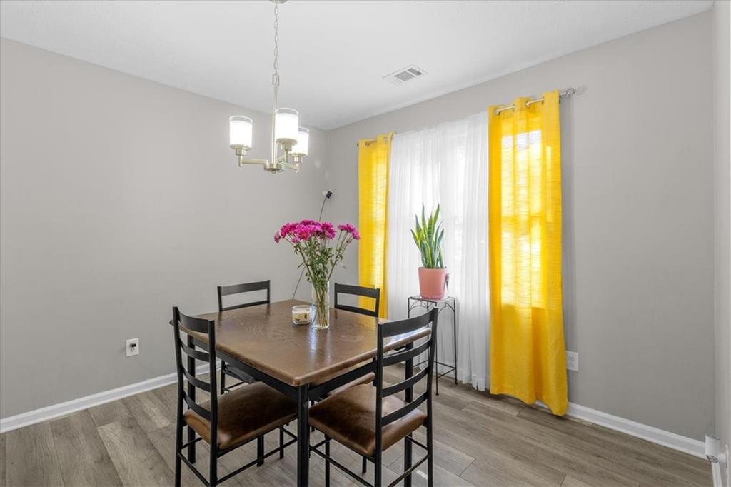 472 Oak Hill Road Covington, GA 30016 - Photo 12 of 41 a view of a dining room with furniture and chandelier