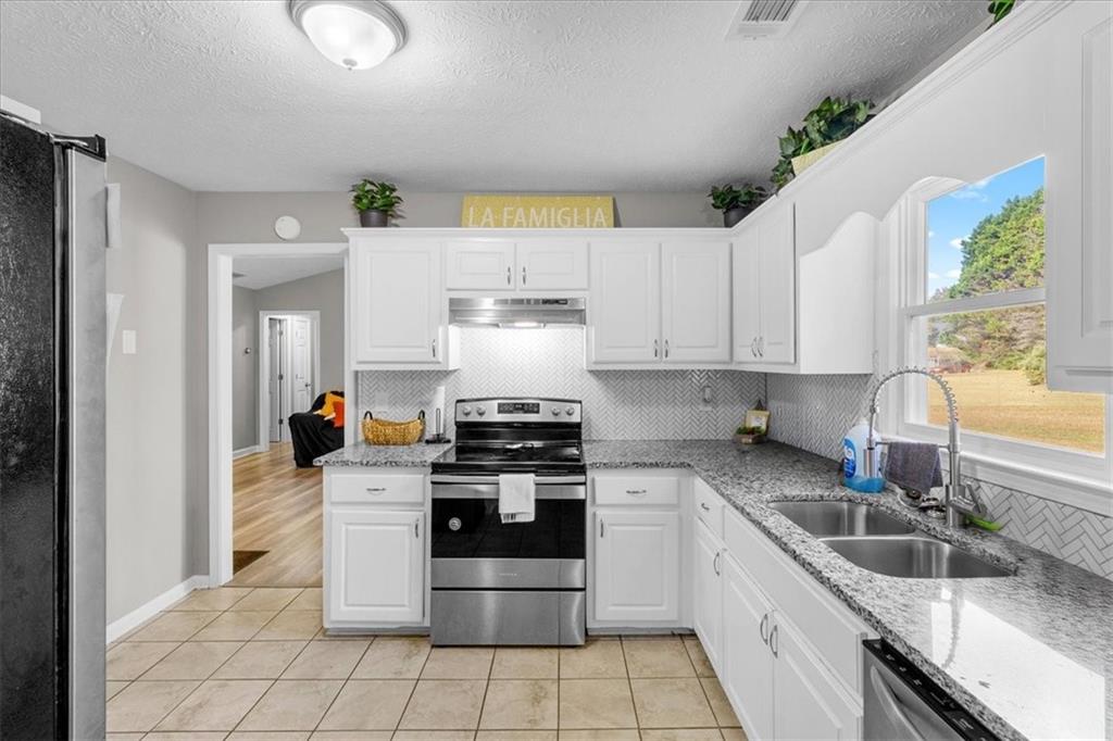 472 Oak Hill Road Covington, GA 30016 - Photo 13 of 41 a kitchen with a sink appliances and cabinets