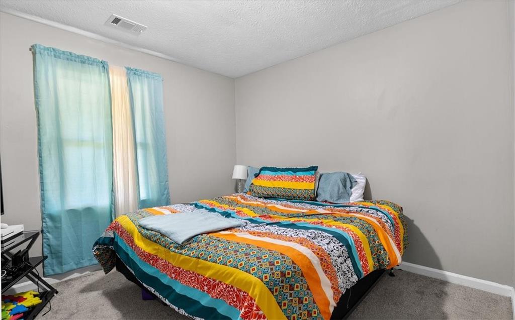 472 Oak Hill Road Covington, GA 30016 - Photo 21 of 41 a bedroom with a bed and a window