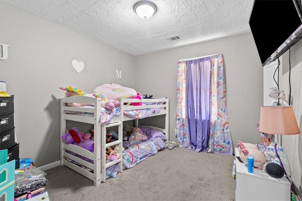 472 Oak Hill Road Covington, GA 30016 - Photo 23 of 41 a bedroom with bed and a window